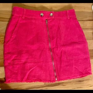 Pink linen mini skirt with front zipper belt loops and snaps.